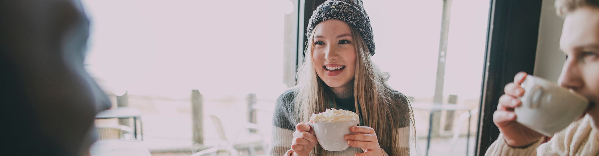 Friends socialise in winter cafe