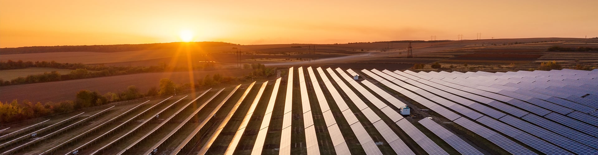 Rows of solar panels in field