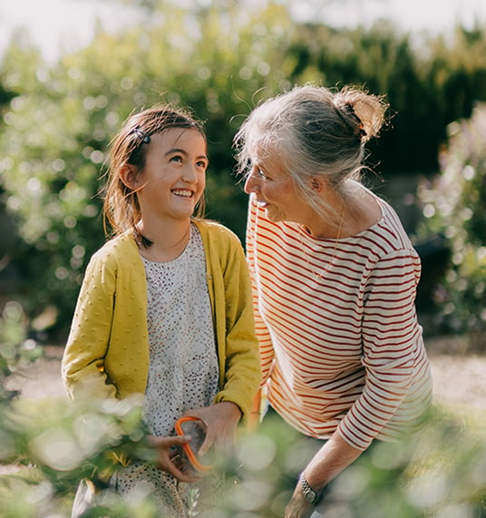 Grandmother and granddaughter are talking in the garden