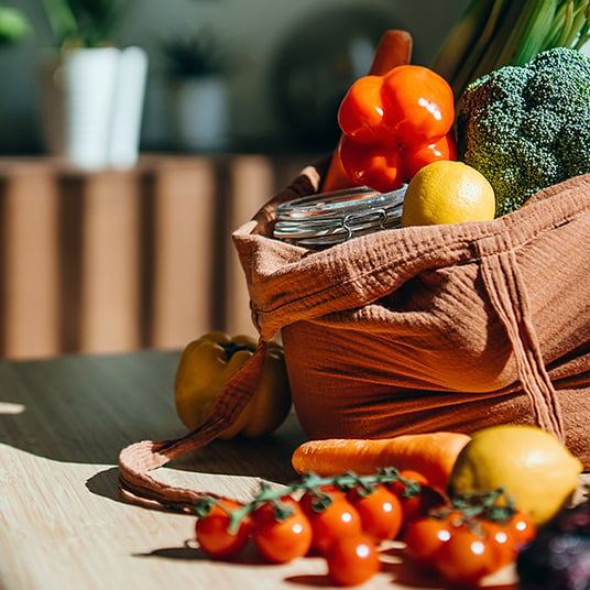 A bag full of vegetables and fruits