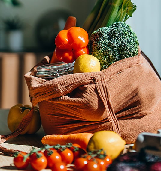 A bag full of vegetables and fruits