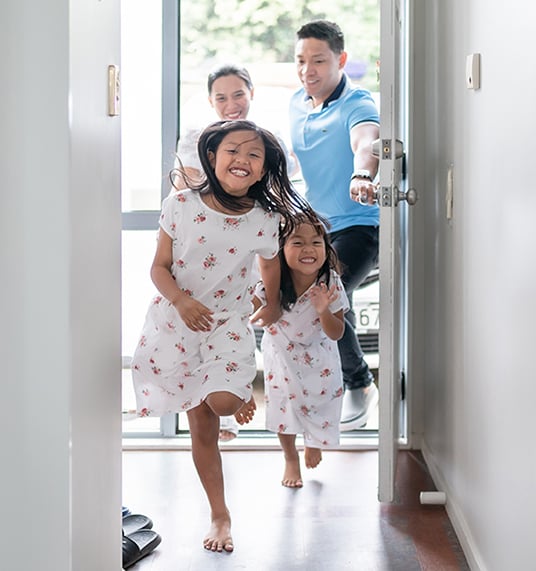 Two joyful girls run through the door