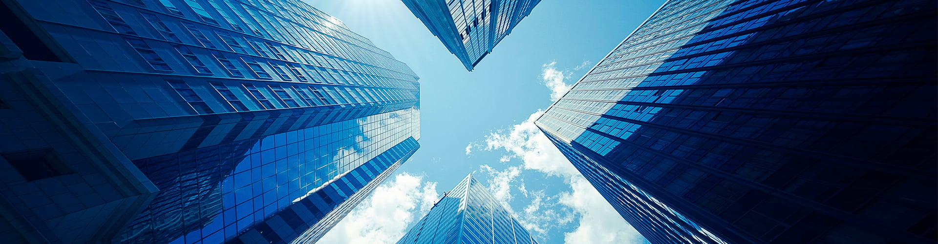 Looking up at four office buildings