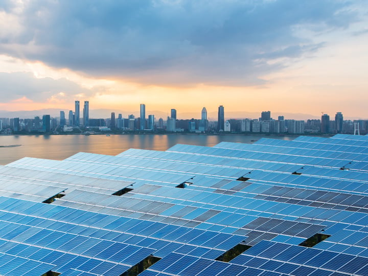 Solar panels with cityscape in background