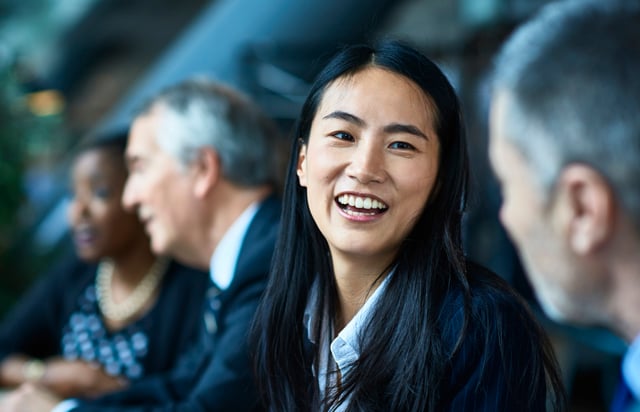 Woman smiling in office meeting