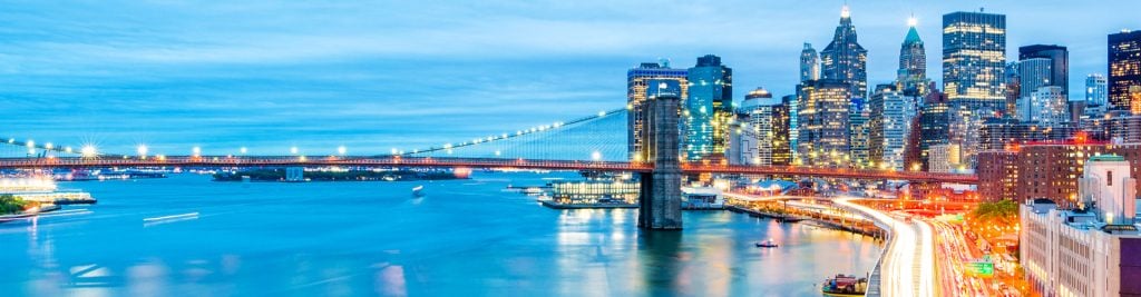 Cityscape with lit up bridge over the water